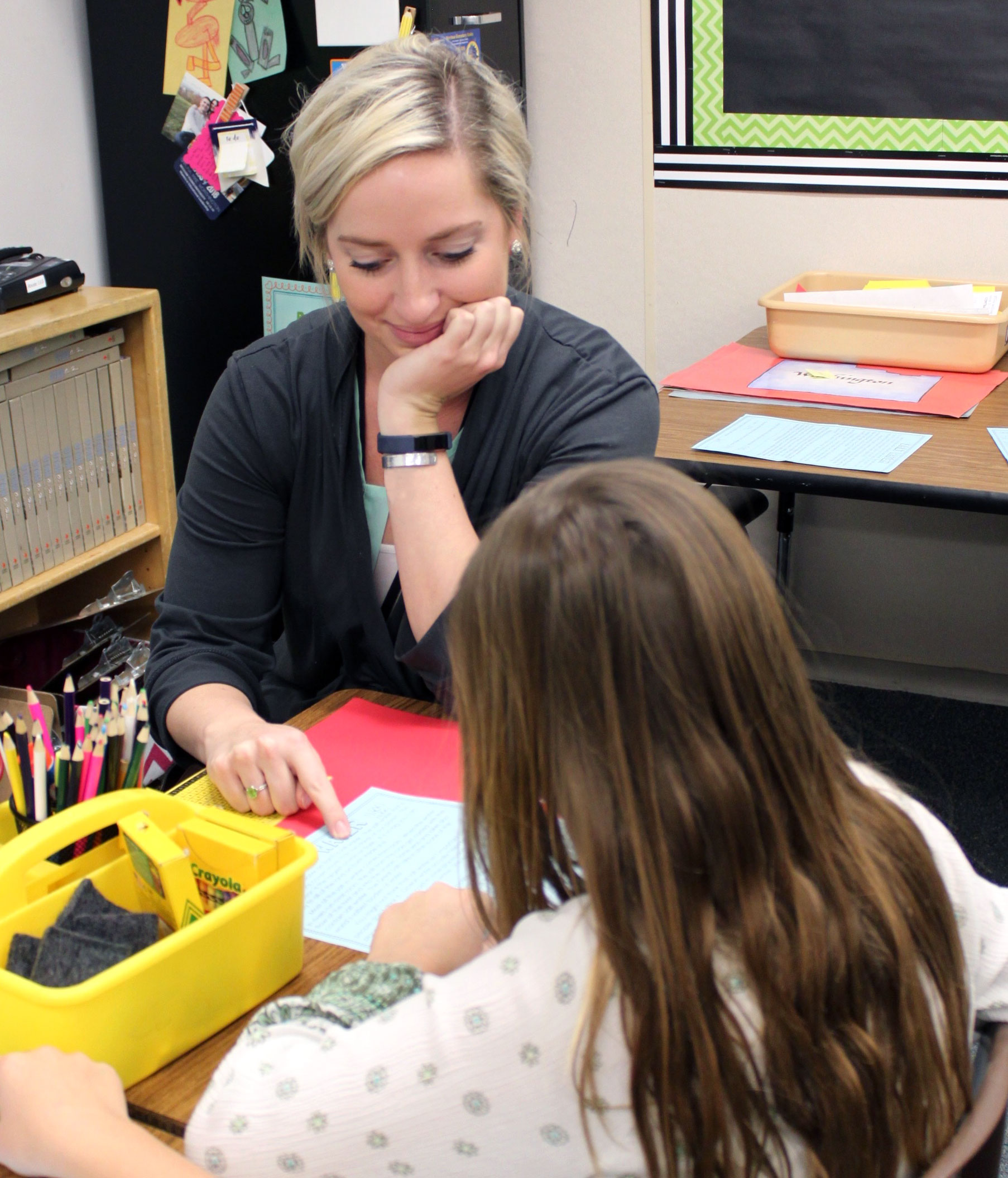 A student teacher works with a student